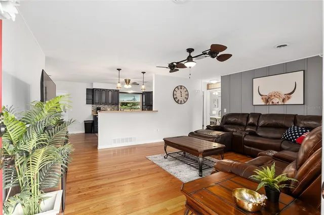 a living room with furniture and wooden floor