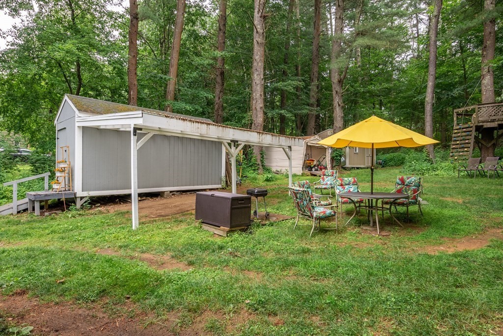 6 Craig Road Holland, MA 01521 - Photo 21 of 28 a view of a house with backyard sitting area and garden