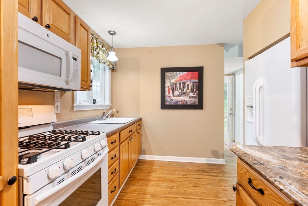 6 Craig Road Holland, MA 01521 - Photo 7 of 28 a kitchen with stainless steel appliances granite countertop a stove a sink and a refrigerator