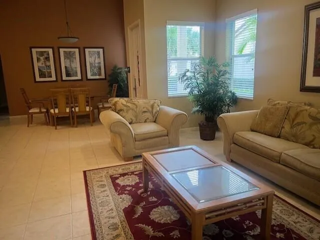 a living room with furniture and a potted plant