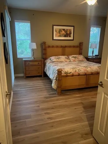 a bedroom with a bed next to a large window