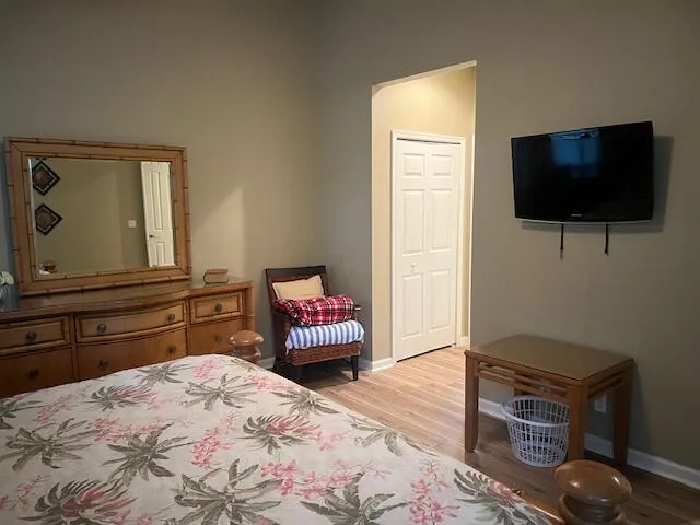 a bedroom with a bed and a flat screen tv