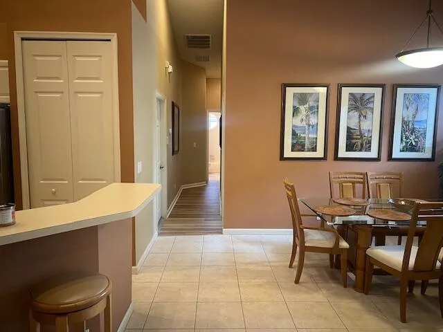 a view of a dining room with furniture and a chandelier