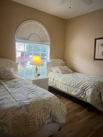 a bedroom with a bed and a potted plant