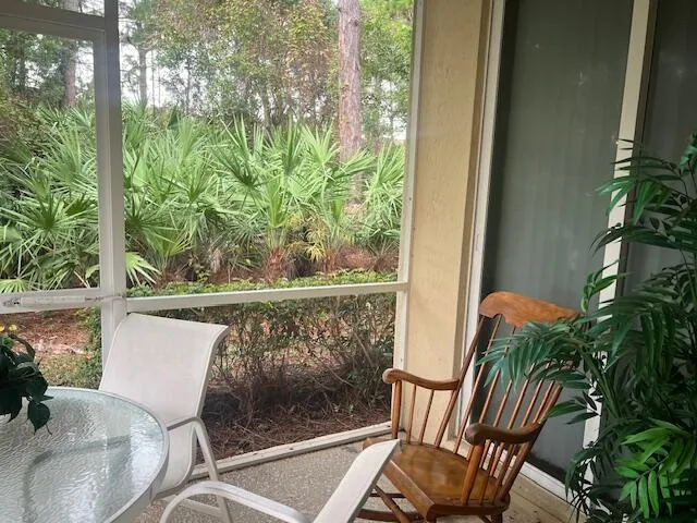 a view of a chair and table in the balcony