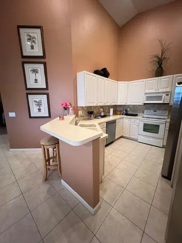 a kitchen with a sink a stove and cabinets