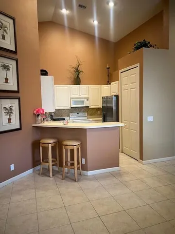 a kitchen with stainless steel appliances granite countertop a sink and cabinets