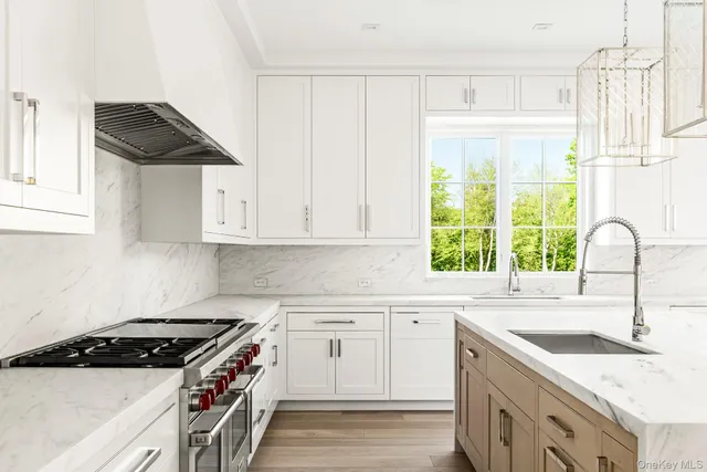 a kitchen with granite countertop a sink a stove and a window