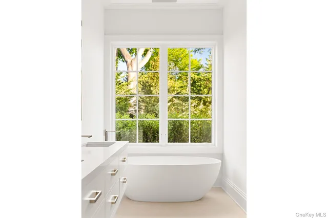 a bathroom with a bathtub and a window