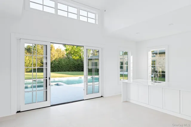 an empty room with large windows