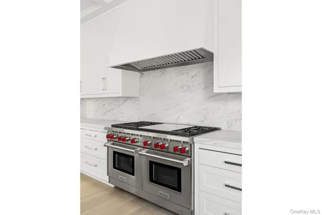 a kitchen with a stove and a white cabinet