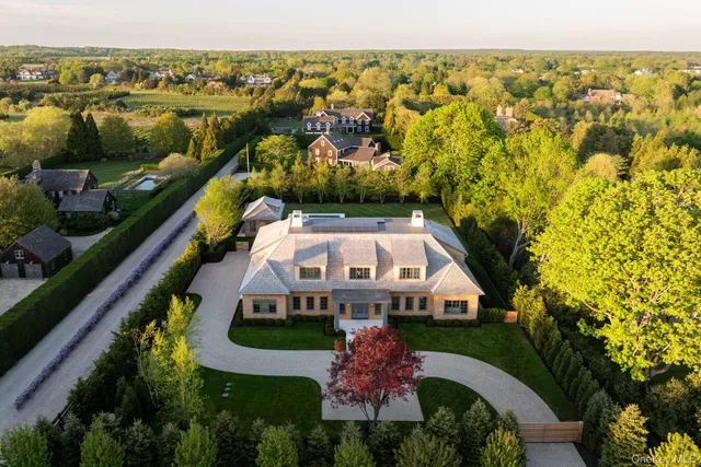 an aerial view of residential house with outdoor space and swimming pool