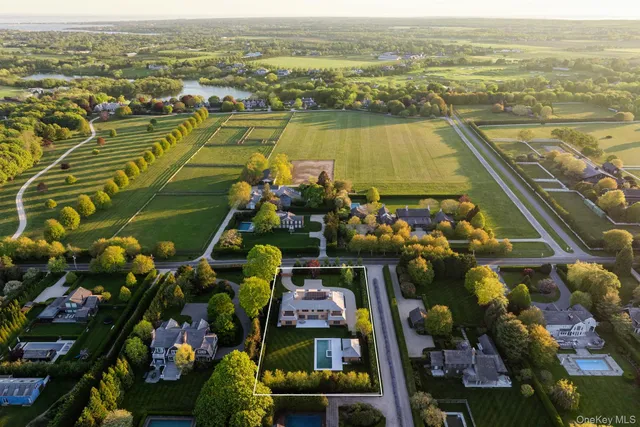 an aerial view of residential building and lake