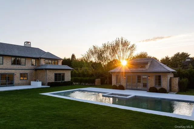 a view of house with garden space and swimming pool
