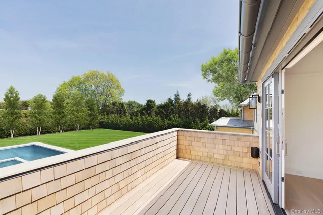 a view of balcony with wooden floor and fence