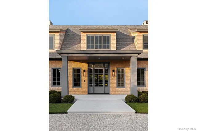 a view of a brick house with many windows