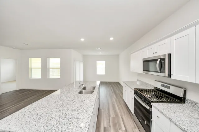 a kitchen with a stove and a white cabinets