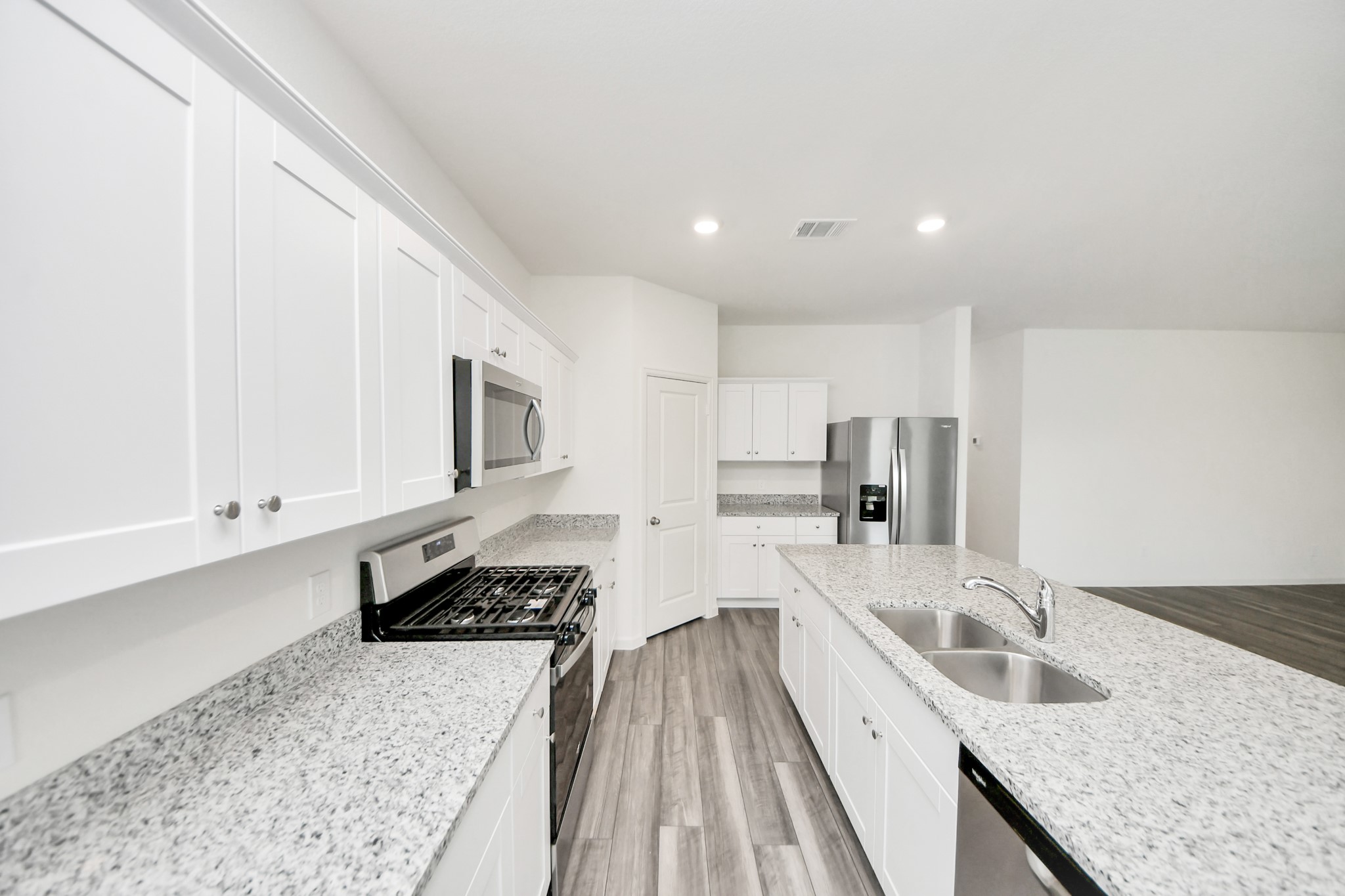 10309 Malta Trce Drive Rosharon, TX 77583 - Photo 12 of 49 a kitchen with stainless steel appliances granite countertop a sink stove and refrigerator