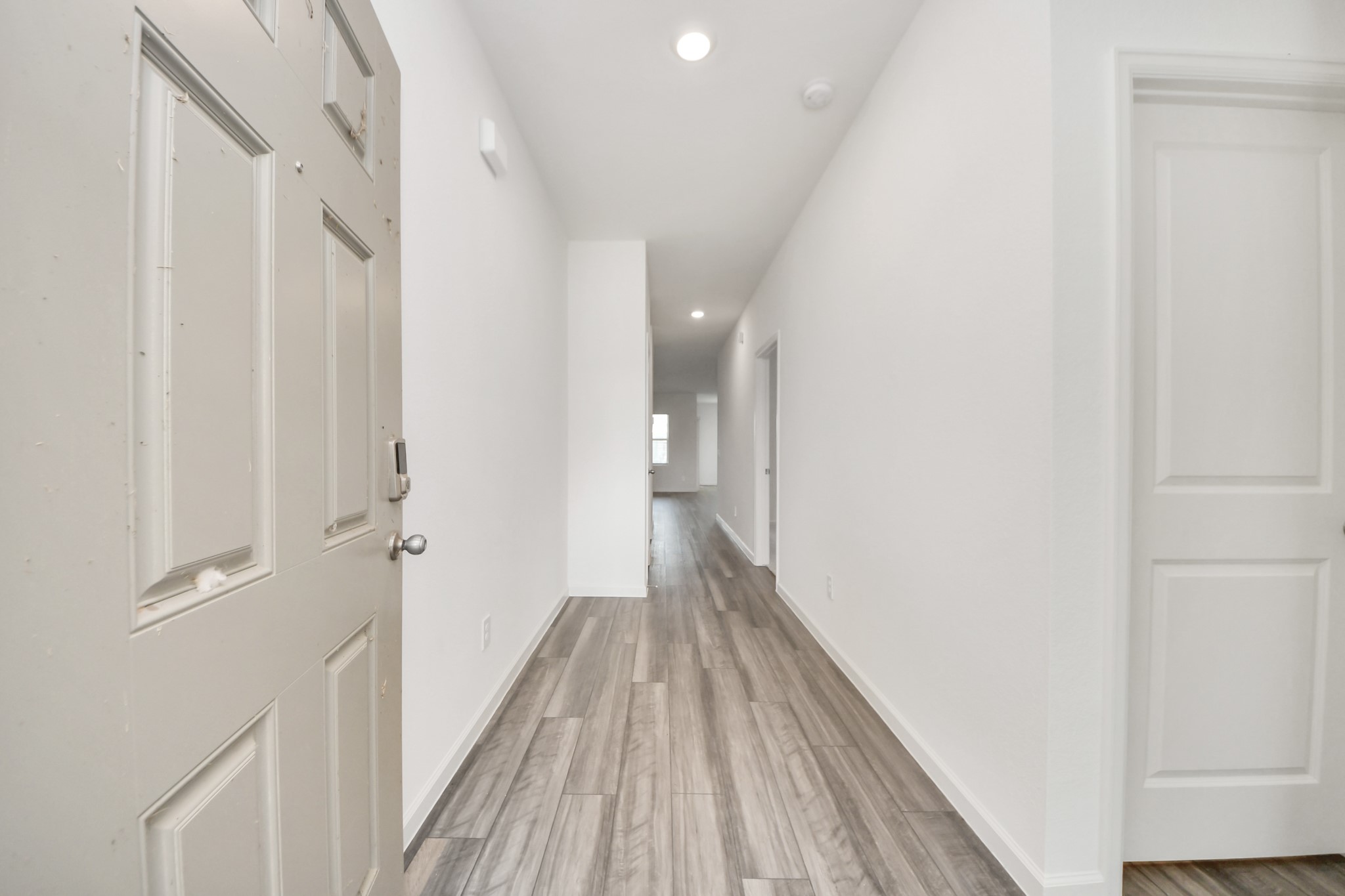 10309 Malta Trce Drive Rosharon, TX 77583 - Photo 14 of 49 a view of a hallway with wooden floor and a bathroom