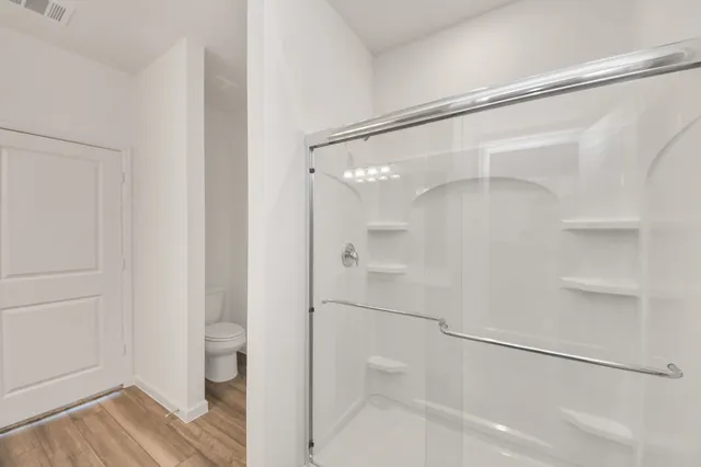 a bathroom with a glass shower door