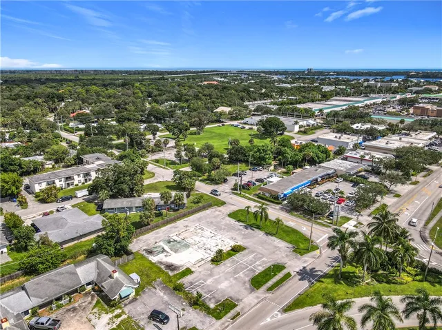 an aerial view of residential houses with outdoor space and river