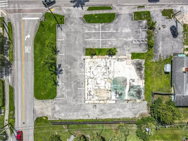 an aerial view of residential houses with outdoor space and trees