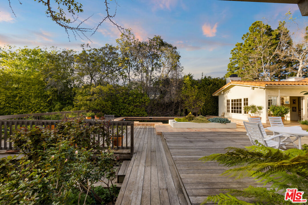 635 North Bonhill Road Los Angeles, CA 90049 - Photo 14 of 19 a house with view of a yard and potted plants