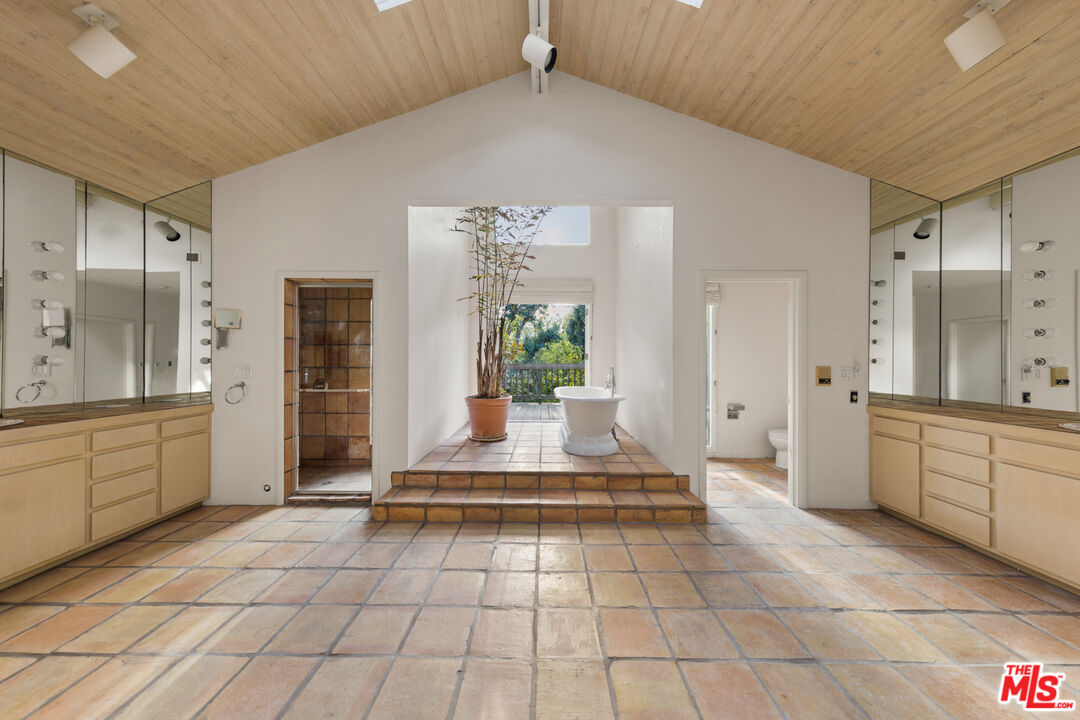635 North Bonhill Road Los Angeles, CA 90049 - Photo 10 of 19 a large white kitchen with granite countertop a sink and cabinets