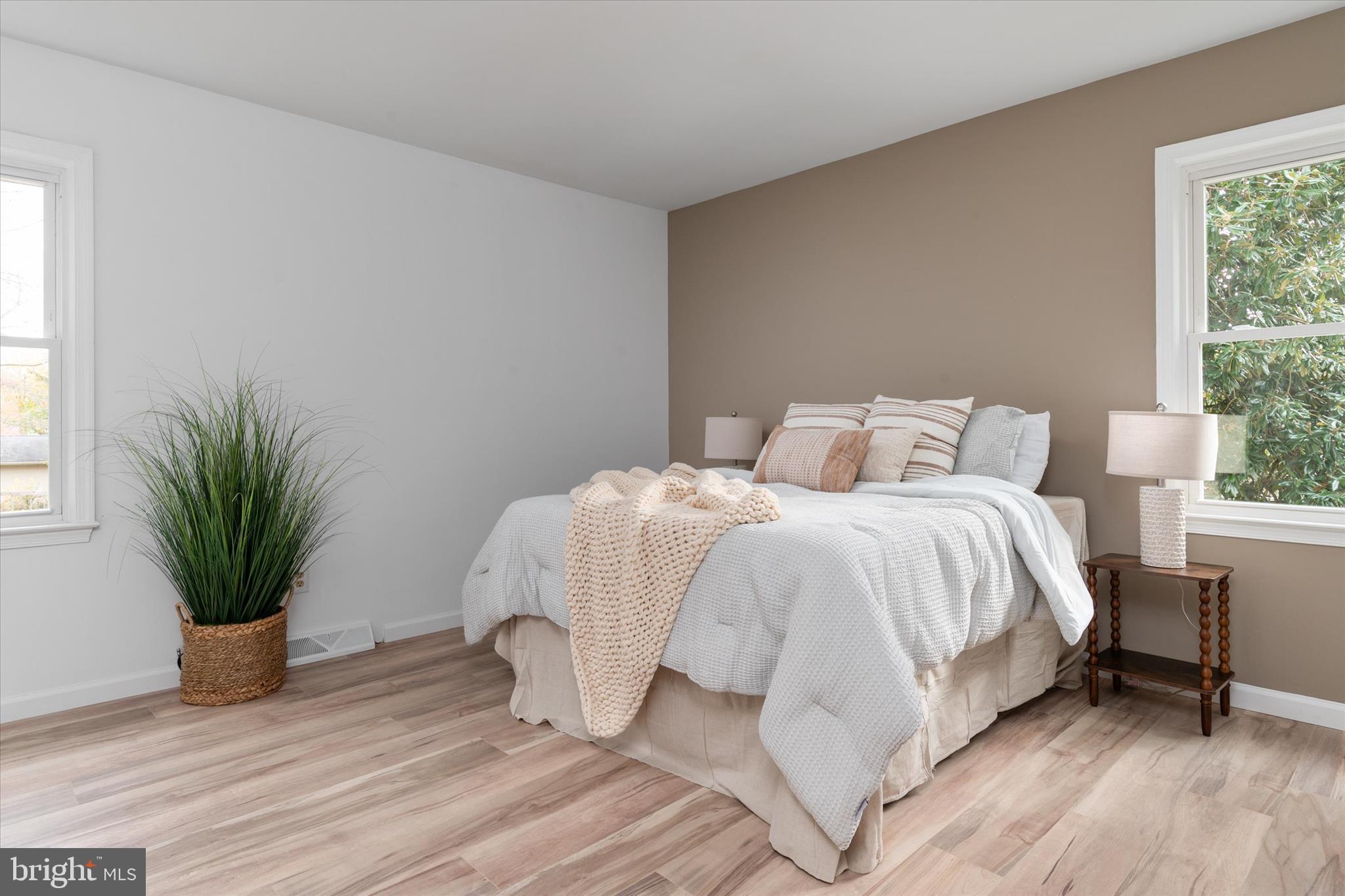 7963 Oak Road Pasadena, MD 21122 - Photo 12 of 53 a bedroom with a bed and a potted plant