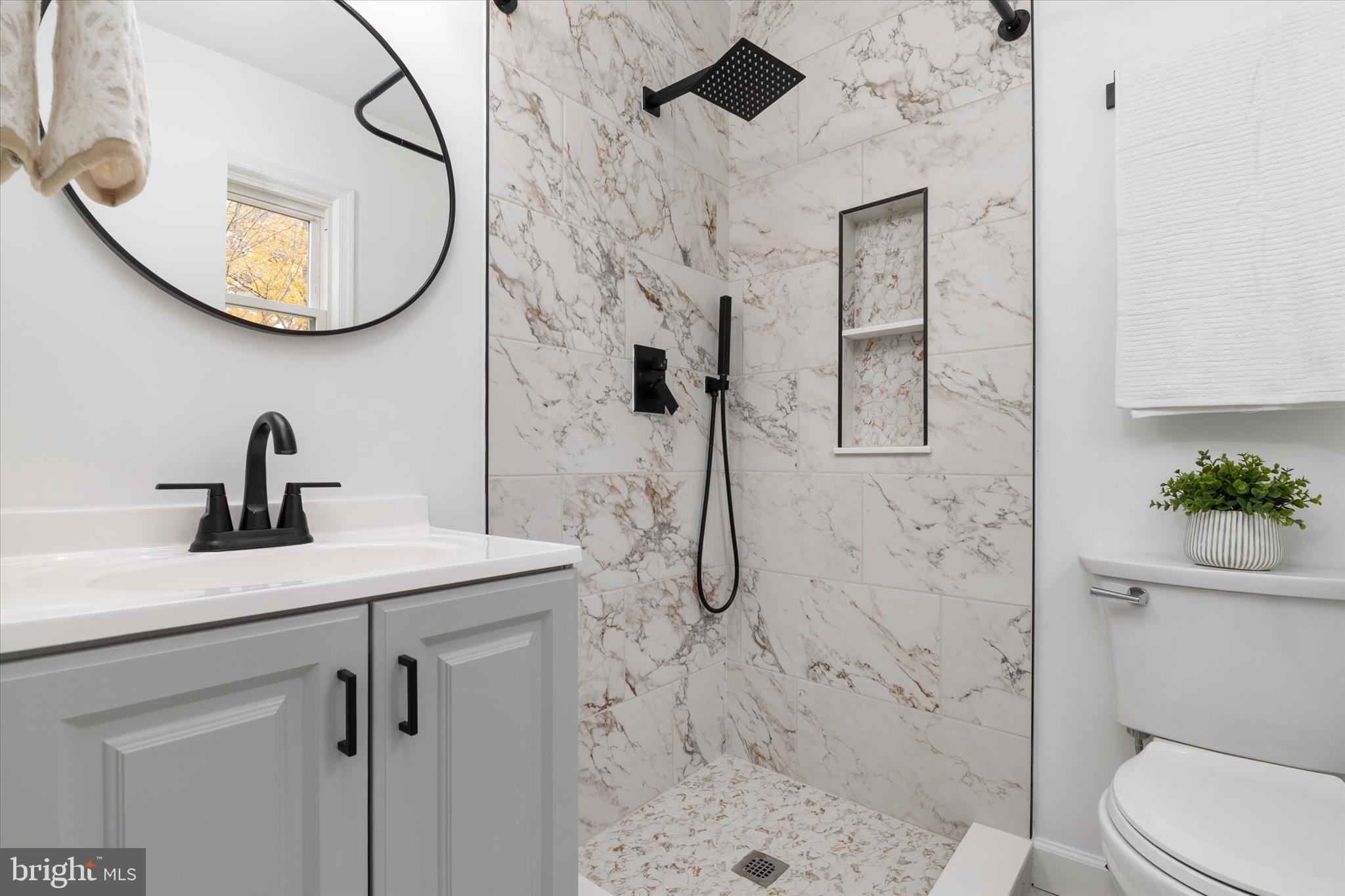 7963 Oak Road Pasadena, MD 21122 - Photo 15 of 53 a bathroom with a sink a toilet and shower