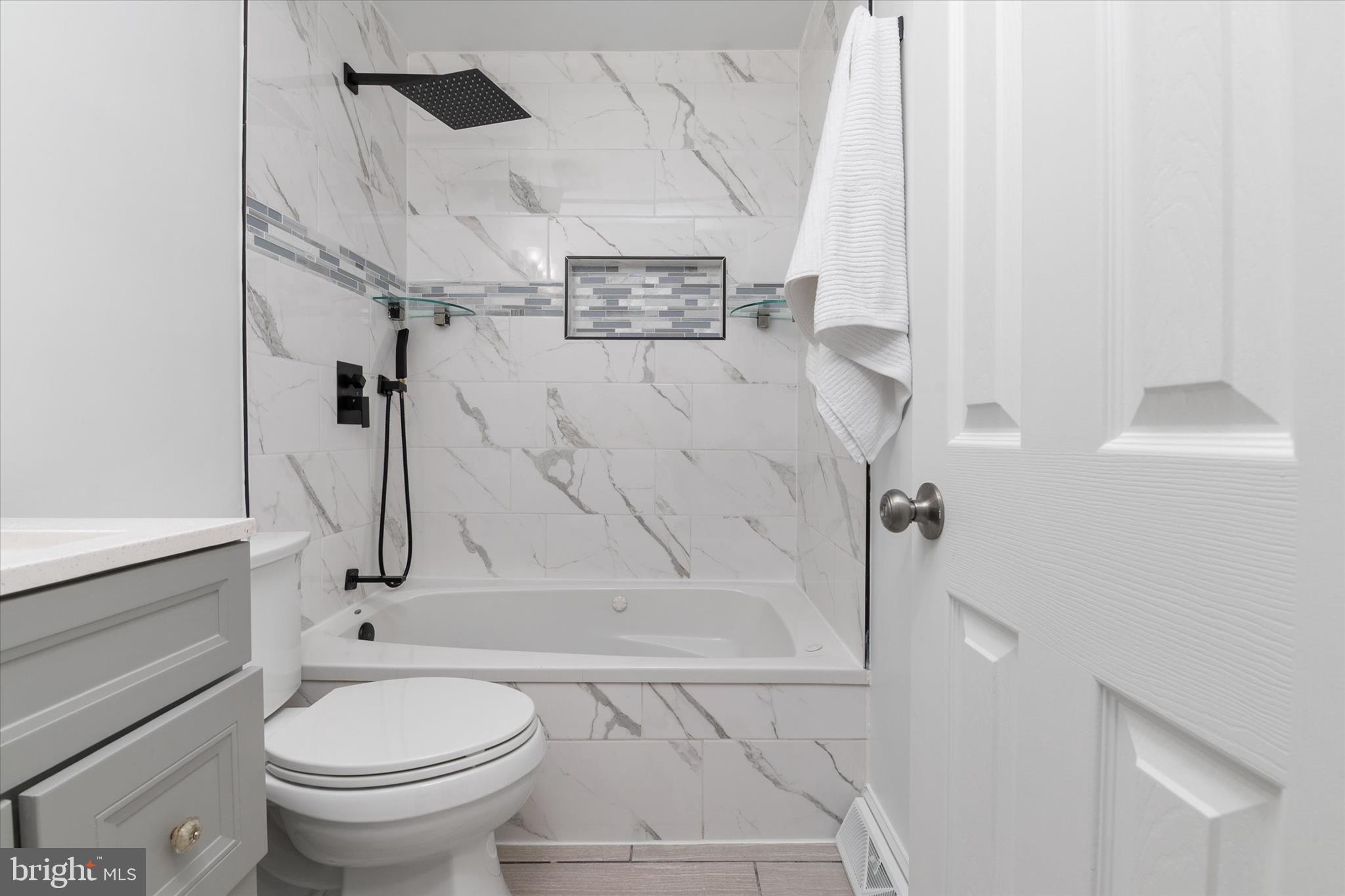 7963 Oak Road Pasadena, MD 21122 - Photo 21 of 53 a bathroom with a toilet and a shower