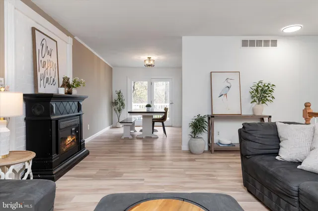 a living room with fireplace furniture and a wooden floor