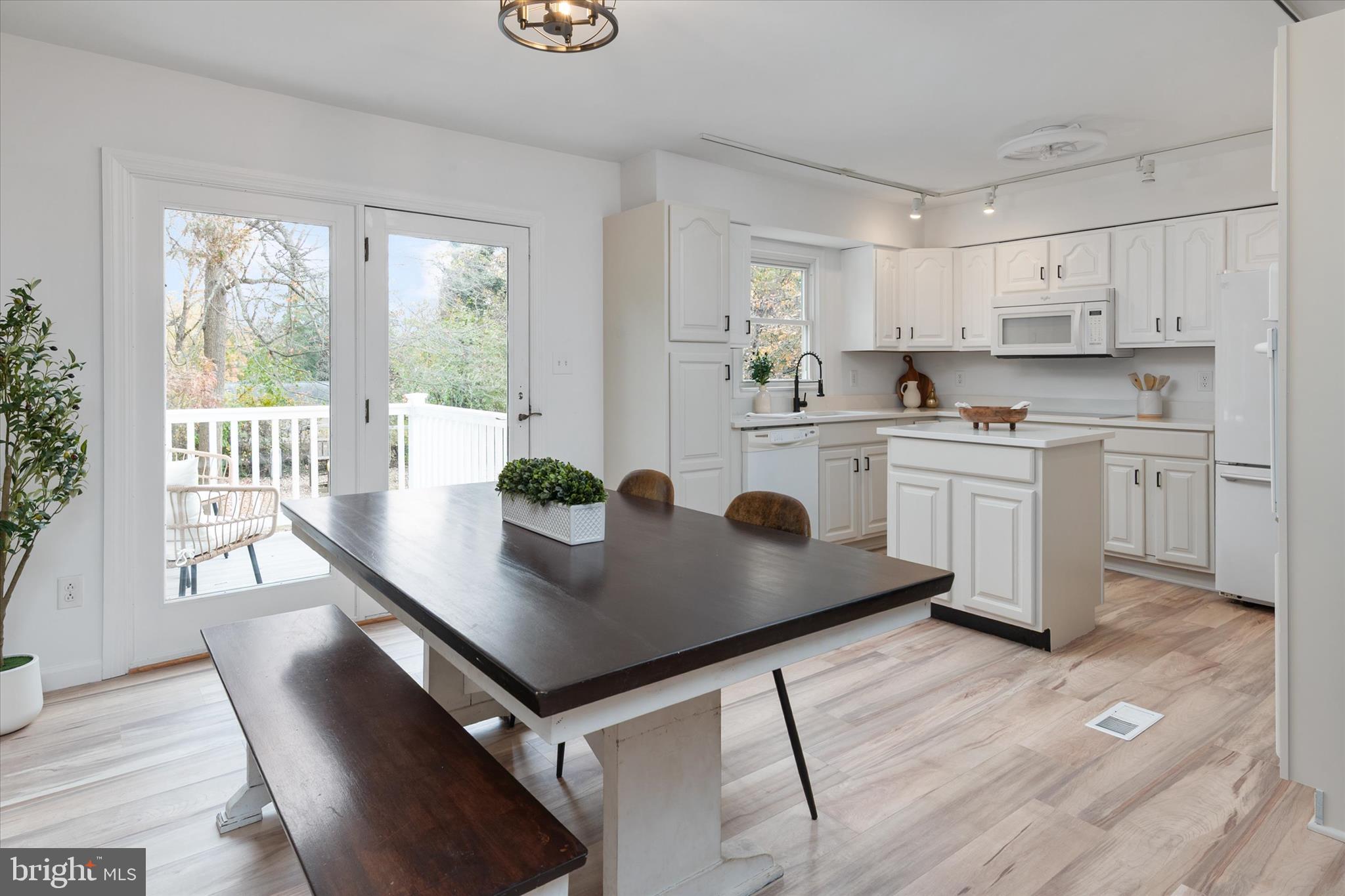 7963 Oak Road Pasadena, MD 21122 - Photo 5 of 53 a view of kitchen with sink dining table and chairs