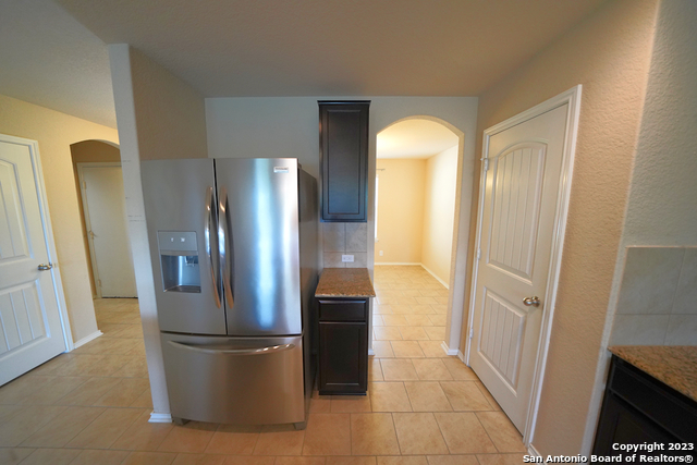 12316 Erstein Valley Schertz, TX 78154 - Photo 17 of 50 a view of a kitchen with a refrigerator and a stove