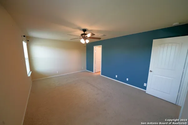 a view of a livingroom with a chandelier fan and a chandelier fan