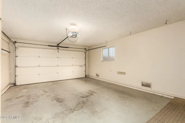 an empty room with white walls and empty racks