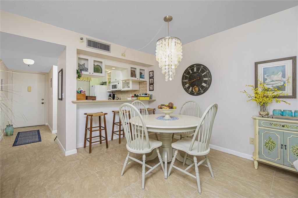 1651 Beach Road, Unit 212 Englewood, FL 34223 - Photo 11 of 50 a view of a dining room and a table and chairs