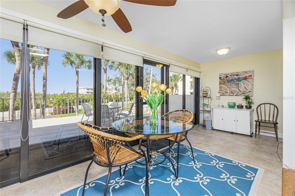 1651 Beach Road, Unit 212 Englewood, FL 34223 - Photo 15 of 50 a dining room with furniture a window and a chandelier