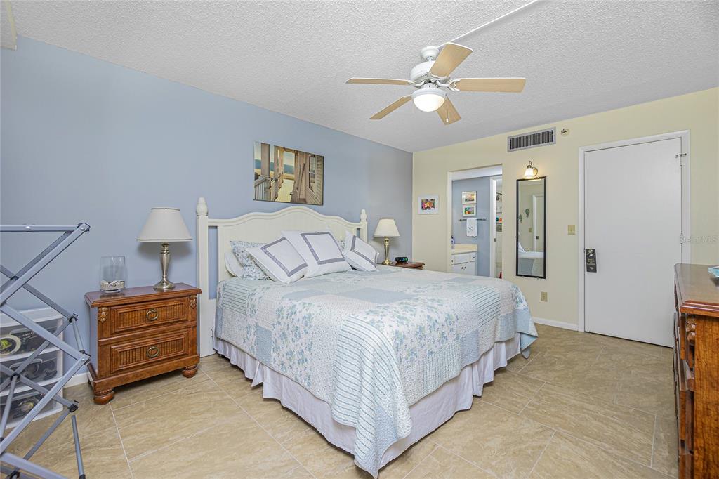 1651 Beach Road, Unit 212 Englewood, FL 34223 - Photo 21 of 50 a bedroom with bed and a chandelier