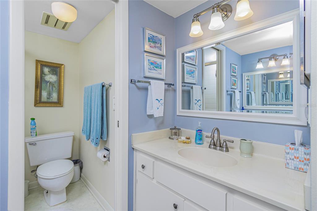 1651 Beach Road, Unit 212 Englewood, FL 34223 - Photo 23 of 50 a bathroom with a toilet sink double vanity and mirror