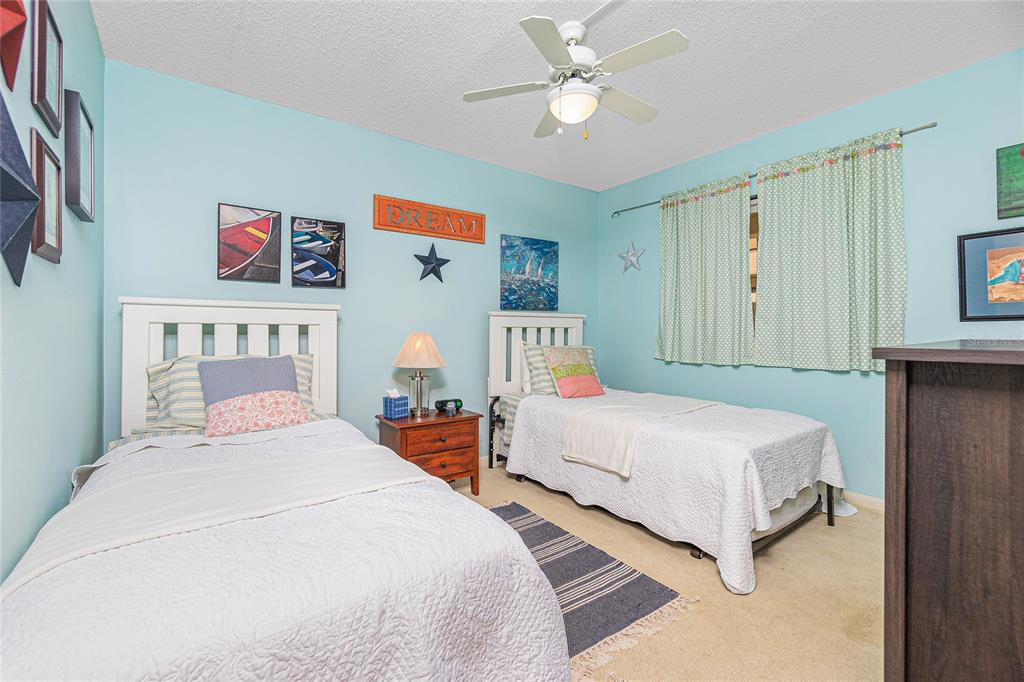 1651 Beach Road, Unit 212 Englewood, FL 34223 - Photo 25 of 50 a bedroom with a bed and a chandelier