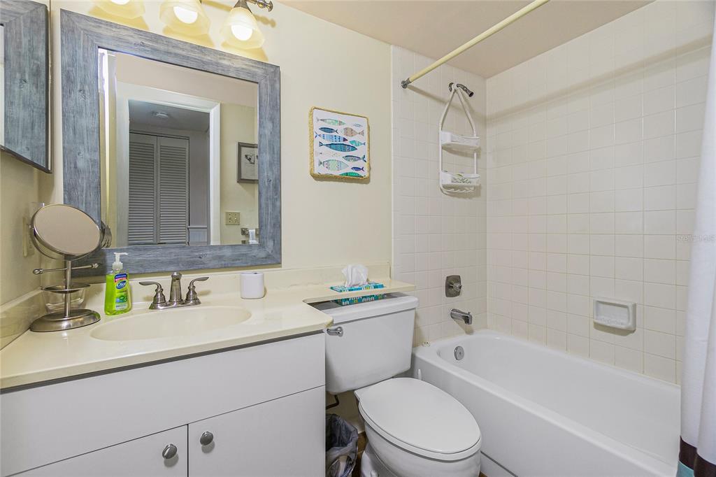 1651 Beach Road, Unit 212 Englewood, FL 34223 - Photo 27 of 50 a bathroom with a sink a toilet and shower