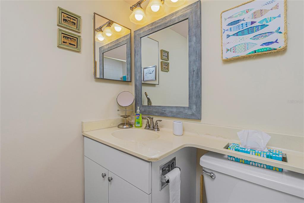 1651 Beach Road, Unit 212 Englewood, FL 34223 - Photo 28 of 50 a bathroom with a sink and a mirror