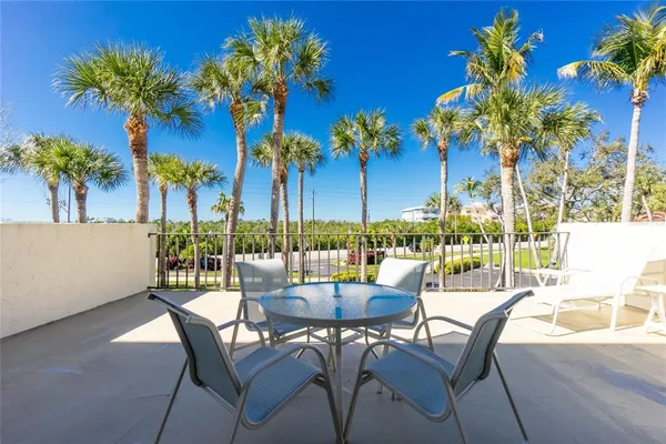 a view of a chairs and table in the patio