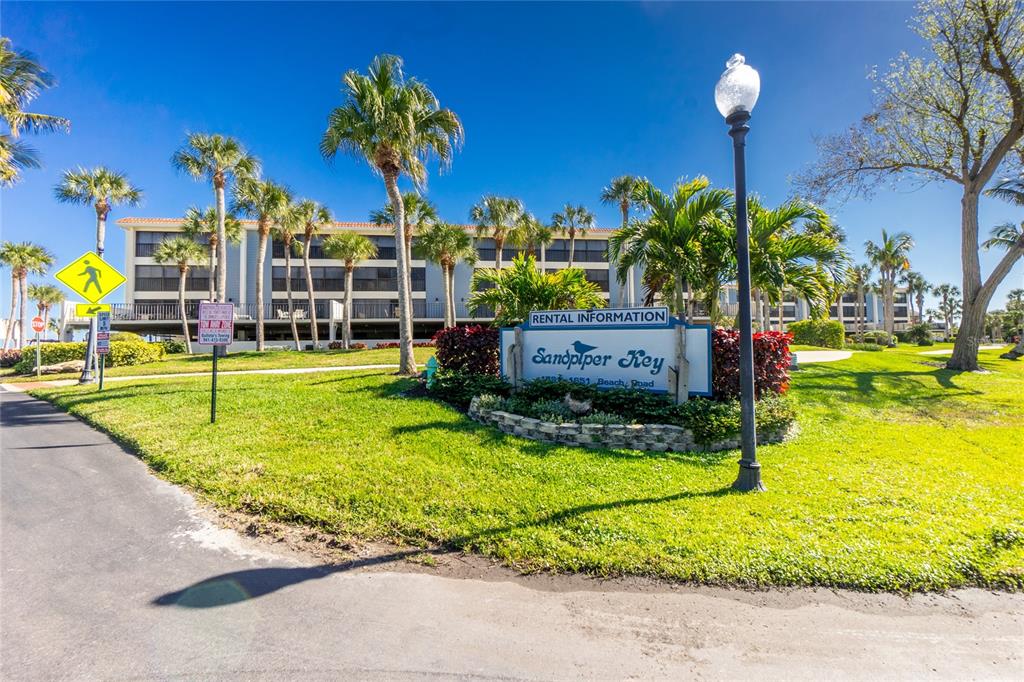 1651 Beach Road, Unit 212 Englewood, FL 34223 - Photo 31 of 50 a view of a yard with table and chairs