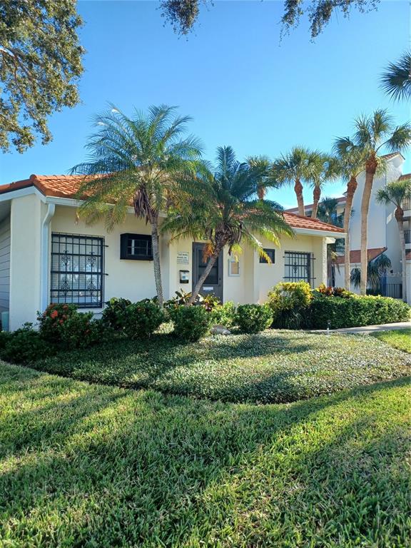 1651 Beach Road, Unit 212 Englewood, FL 34223 - Photo 44 of 50 a view of a white house with a yard and potted plants