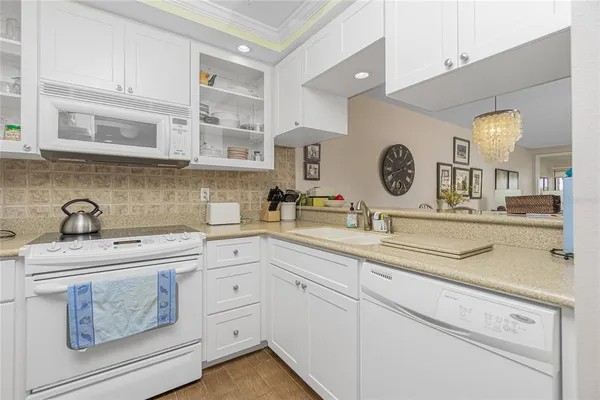 a kitchen with cabinets stainless steel appliances and a sink