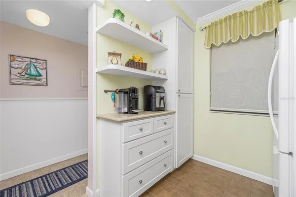 a room with a refrigerator and cabinets