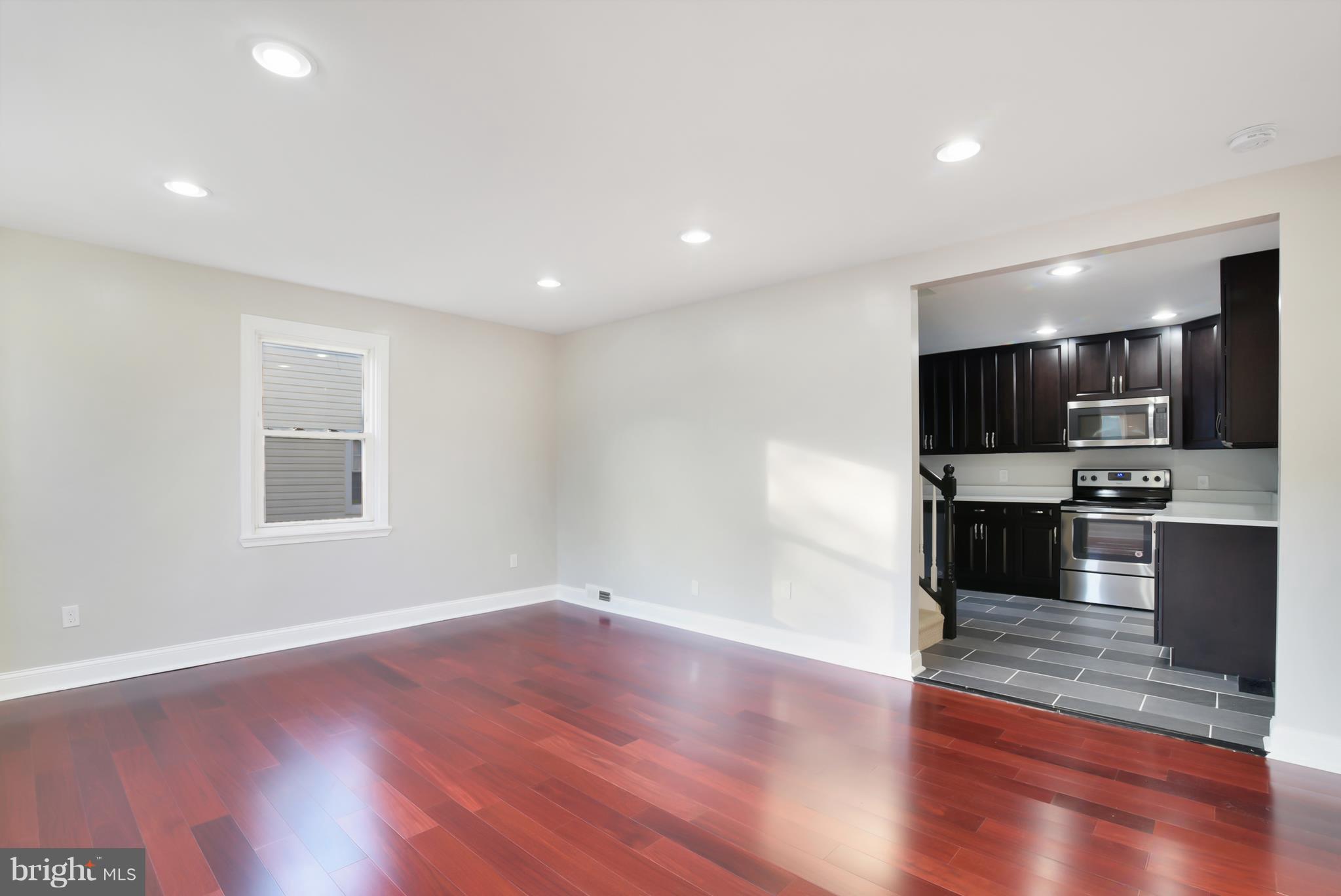 7116 Marston Road Baltimore, MD 21207 - Photo 1 of 30 a view of kitchen with cabinets and wooden floor