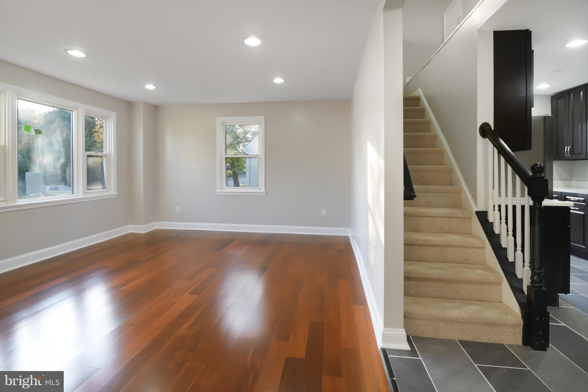 7116 Marston Road Baltimore, MD 21207 - Photo 2 of 30 an entryway in a hall with wooden floor and a window